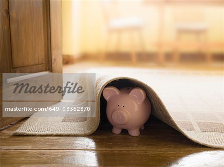 Piggy bank under rug