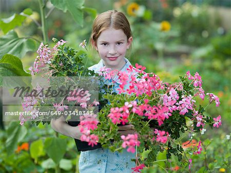A young girl with flowering pot plants