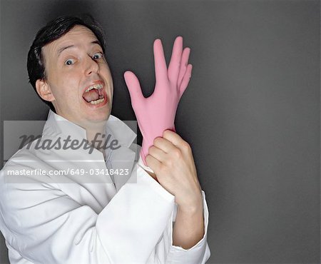 man putting rubber glove on