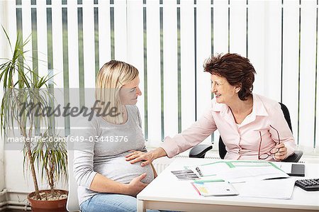 Woman consulting pregnant woman