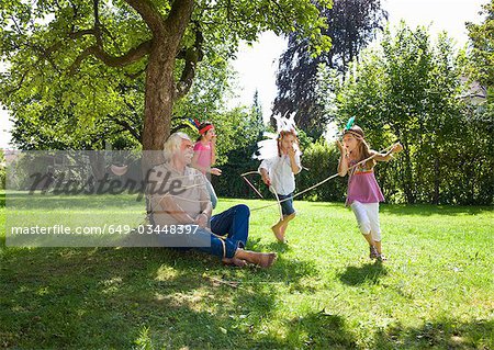 Grandchildren tie grandfather to tree Grandchildren tie grandfather to tree