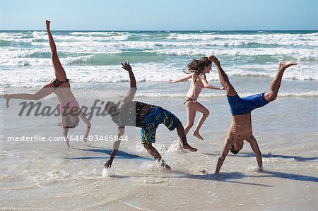 Young group frolicking on beach