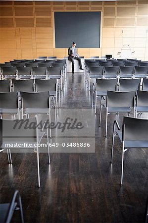 Businessman at head of empty conference