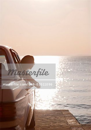 Woman with oldtimer by sea