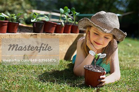Young girl looking at vegetable plant