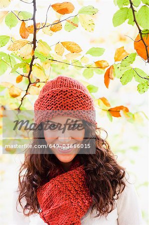 young woman below trees