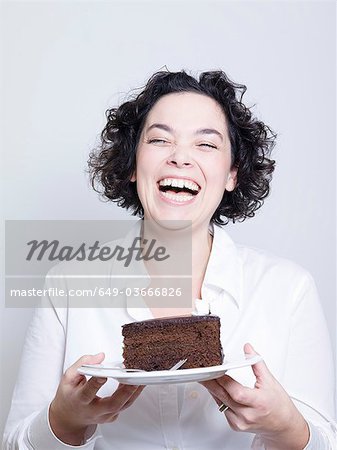 woman holding a plate of cake