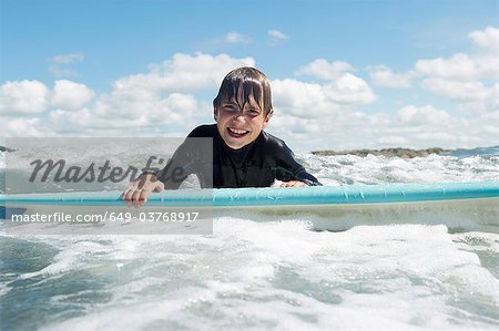 Young boy on surf board in the sea