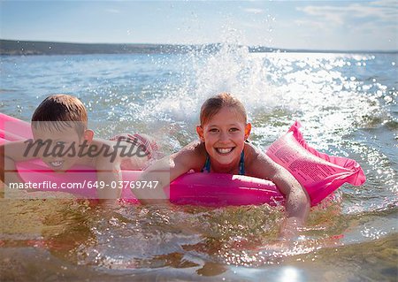Children swimming with inflatable