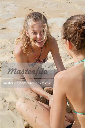 Two pretty women having a mud bath Stock Photo Masterfile