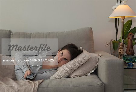 Young woman holding TV remote