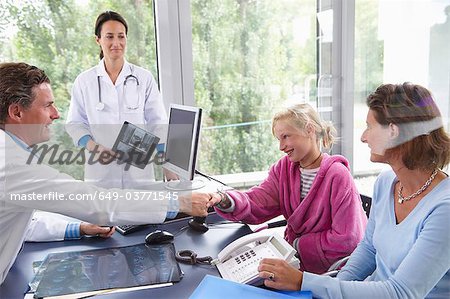 Doctors with patients, in office