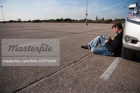 Man writing in parking lot