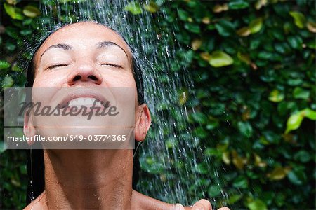 Smiling colored woman in the shower