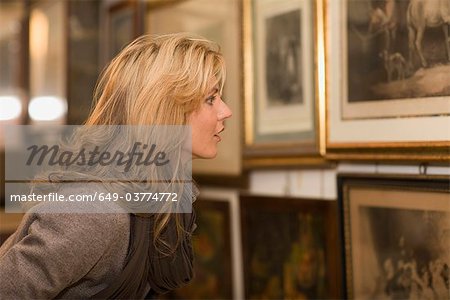 Woman looking up to painting