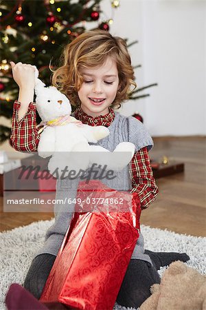 Girl putting bunny out of present
