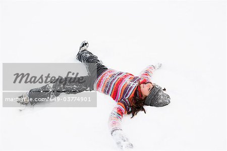 Girl making snow angel