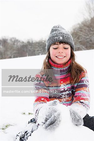 Girl building snowman