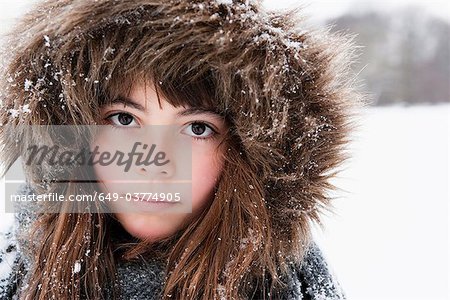 Girl with fur cap looking to camera