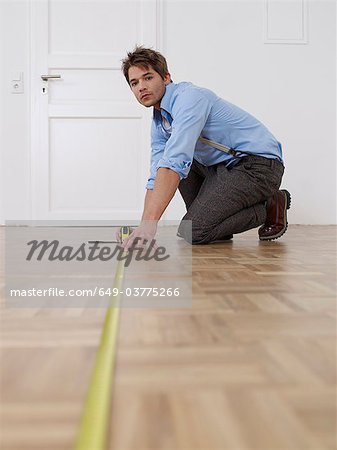 Young man measuring flat