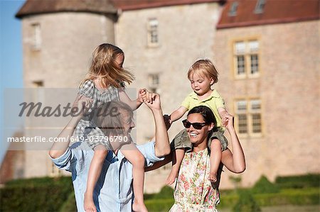 Mom and dad with kids on their shoulders