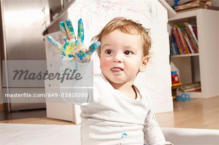 Boys hand covered with finger paint