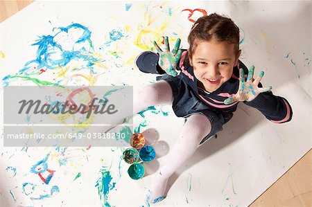 Little girl playing with finger paint