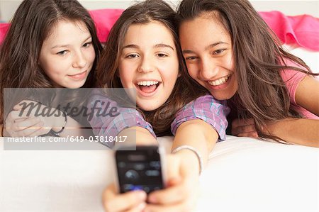 teenage girls taking photos wearing pajamas