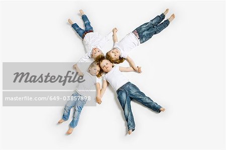 Four toddlers laying in formation