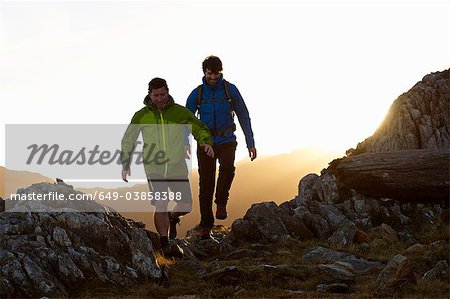Men hiking on rocky mountainside Men hiking on rocky mountainside