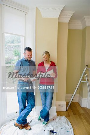 Couple examining plans in new home