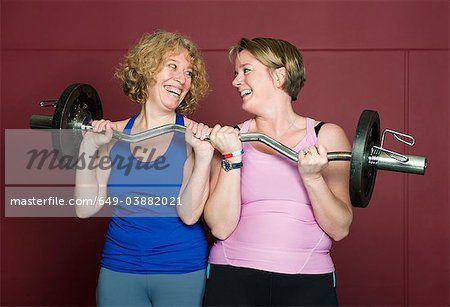 Older women lifting weights in gym