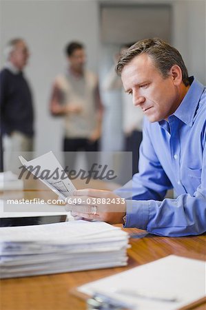 Businessman reading in meeting