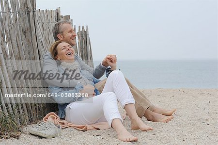 Older couple hugging on beach