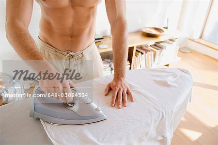 Man ironing shirt