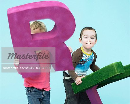 Toddlers playing with oversize letters