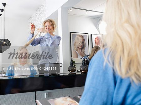 Hairdresser cutting woman's hair