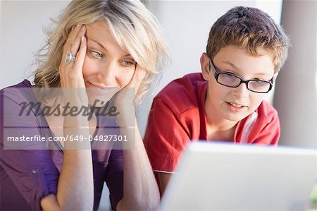 Mother and son using laptop together Mother and son using laptop together