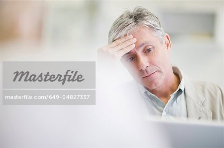 Stressed businessman working in office