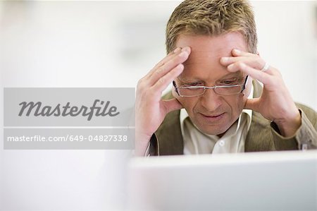 Stressed businessman working in office