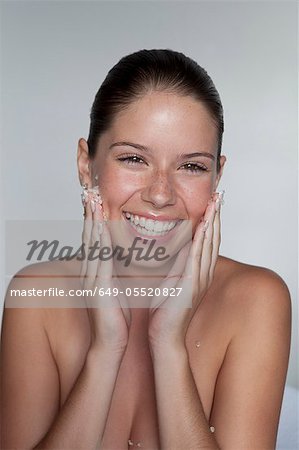 Woman scrubbing sugar on her face