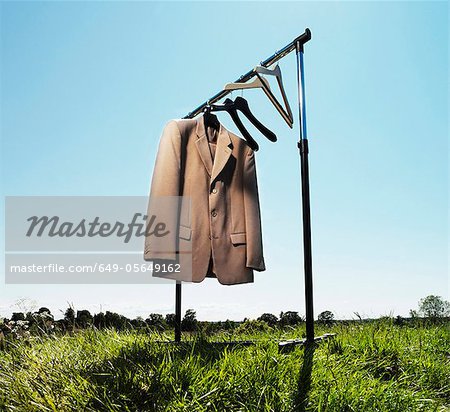 Suit jacket hanging in field