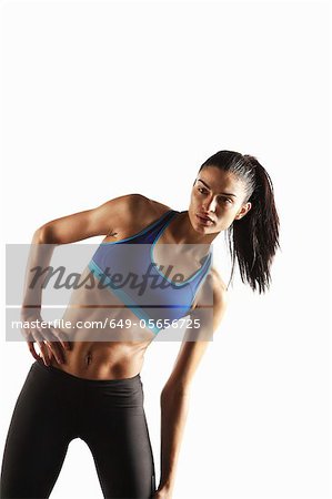 Athlete stretching with hand on hip