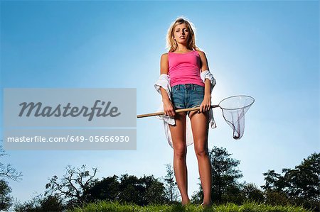 Woman holding butterfly net outdoors