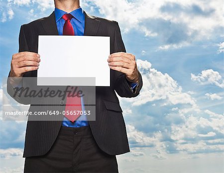 Businessman holding blank card