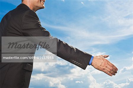 Businessman holding out hand to shake