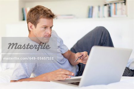 Man shopping online with laptop