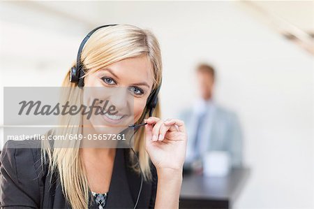 Businesswoman wearing headset at desk