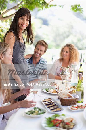 Friends eating at table outdoors