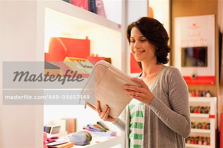 Woman admiring laptop case in store